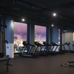 Modern gym interior at Moda, Holland Park featuring treadmills and city views, highlighting fitness amenities for residents in Glasgow's cultural quarter.