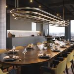 Modern dining area with elegant table setting, featuring stylish tableware and a contemporary light fixture, showcasing the upscale amenities of the studio apartment at 50 Holland Street, G2 4BD, available for rent.