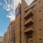 Modern brick building exterior with balconies, situated in Edinburgh, showcasing stylish architecture relevant to the 1-bedroom unfurnished flat available for rent at 6/3 Brandfield Street.
