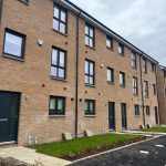 Four-bedroom terraced house exterior in South Queensferry, featuring modern brick façade, large windows, and landscaped front garden.