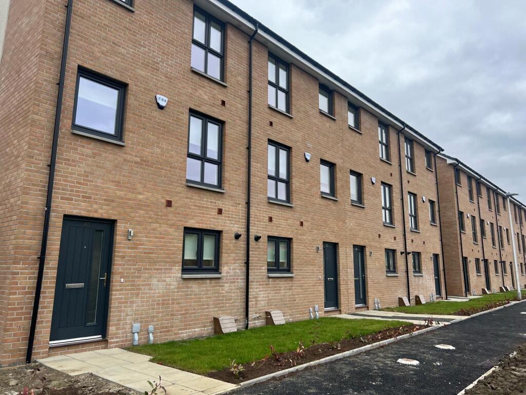 Terraced house exterior in South Queensferry, featuring brick facade, multiple windows, and front doors, available for rent as unfurnished accommodation.