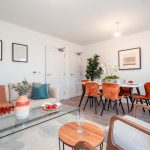 Living and dining area of a 4-bedroom unfurnished terraced house in South Queensferry, featuring modern decor, dining table, and stylish seating.